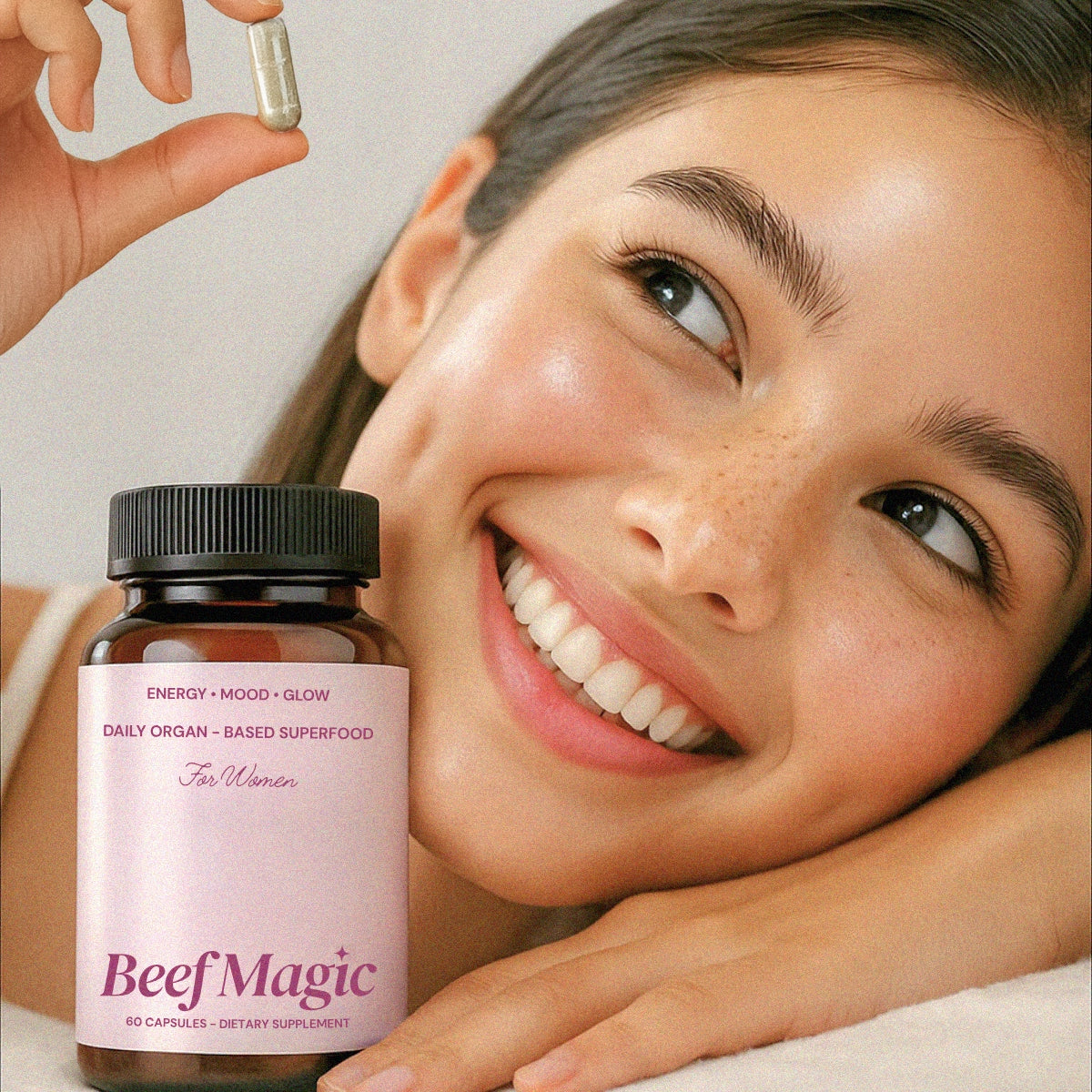 Woman holding Beef Magic daily organ superfood. Supplement for women supporting energy, mood, and natural skin glow.